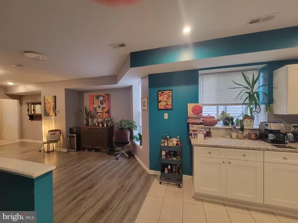 a room with wooden floor and furniture