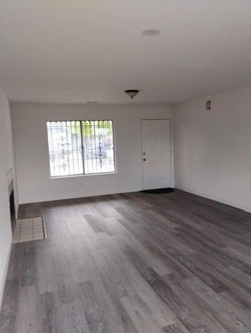 2540 Jordan Court Stockton, CA 95205 - Photo 4 of 5 an empty room with wooden floor and windows