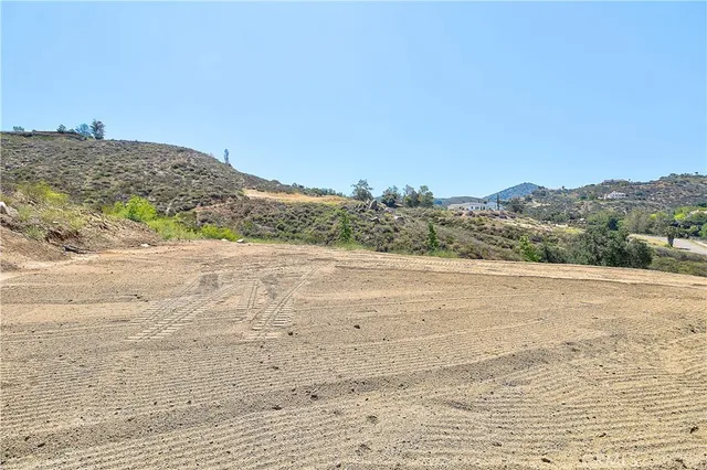 a view of a road with mountains in the background