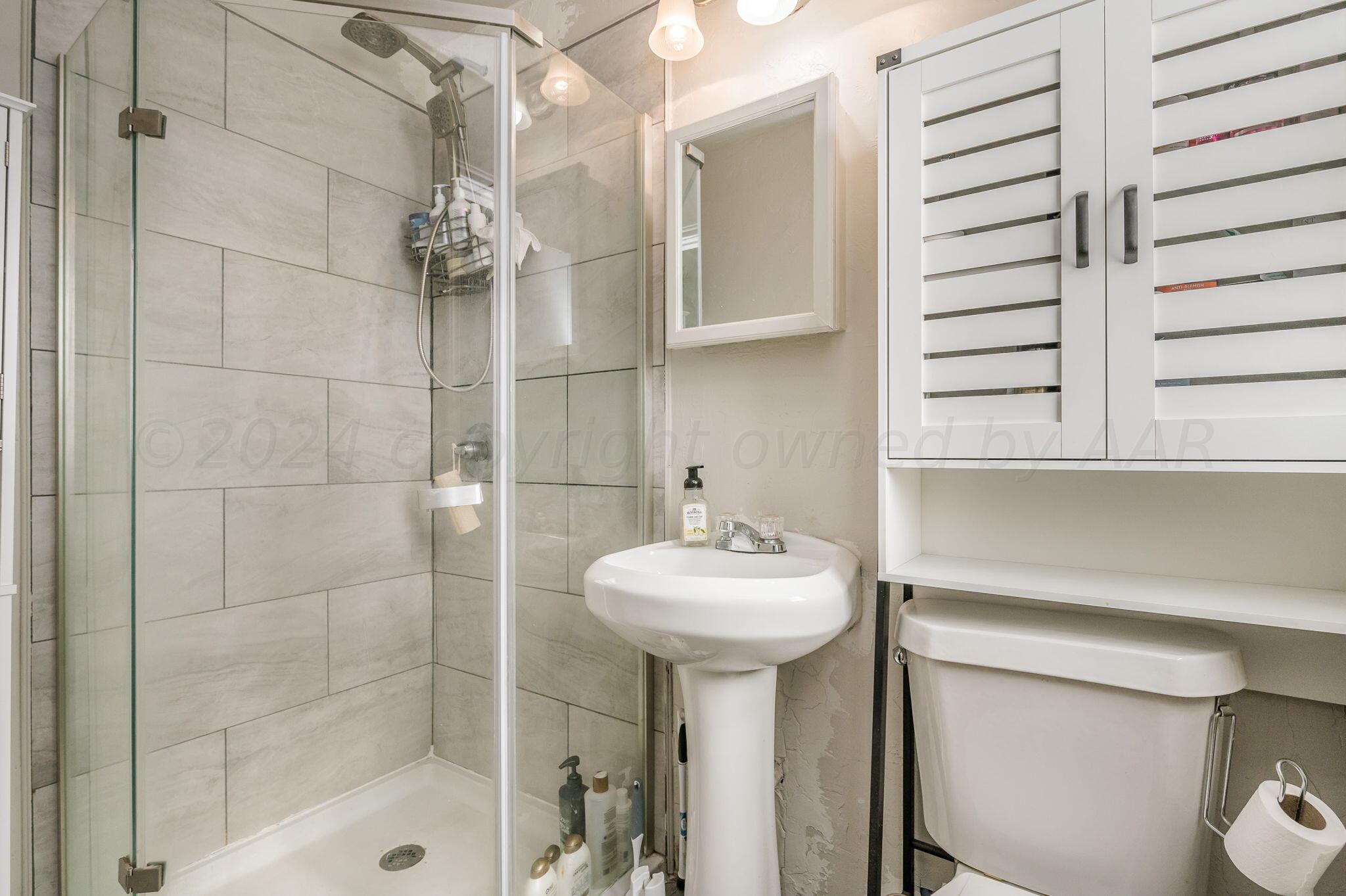 4205 South Bonham Street Amarillo, TX 79110 - Photo 13 of 24 a bathroom with a sink a toilet and shower