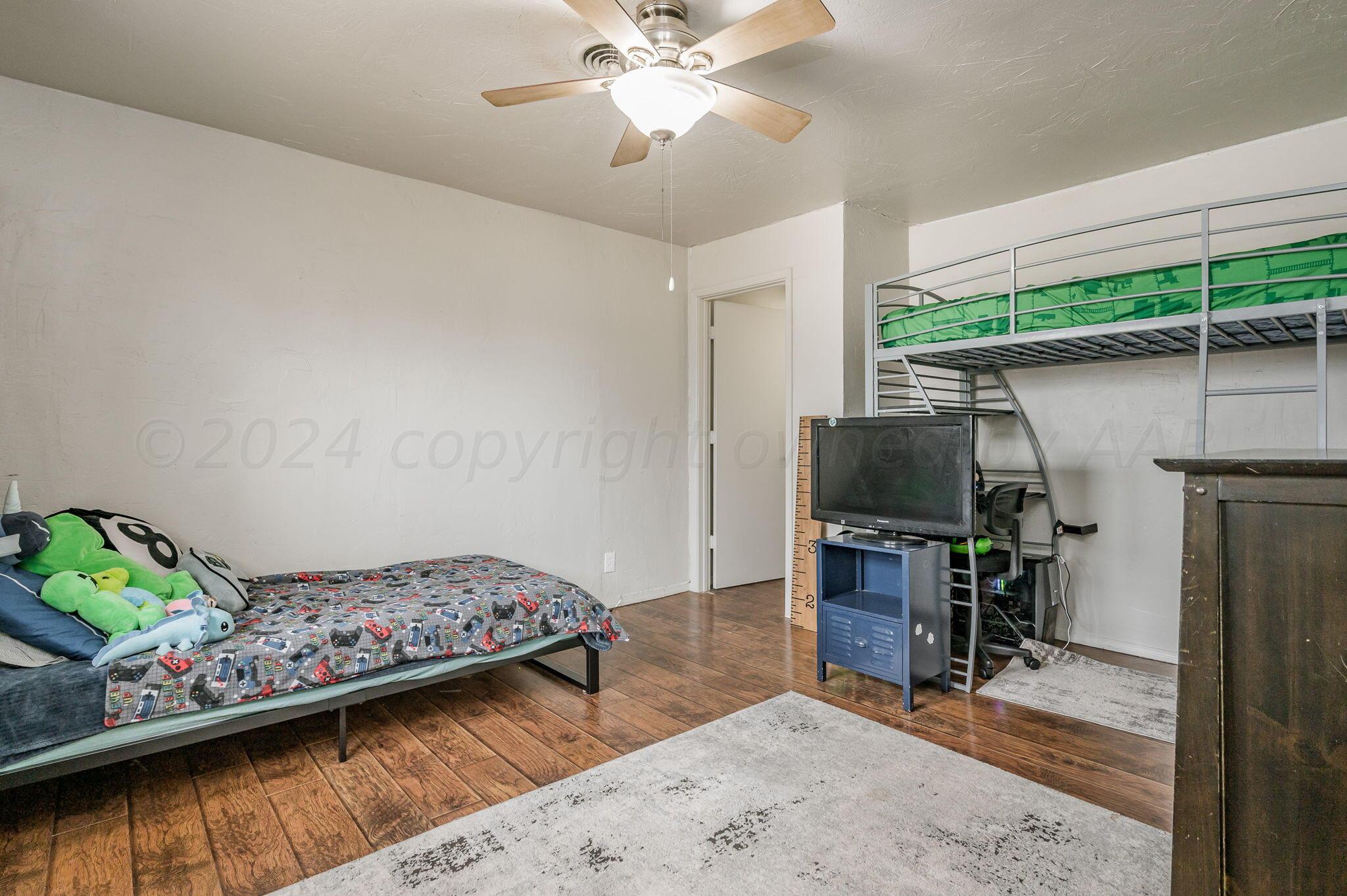 4205 South Bonham Street Amarillo, TX 79110 - Photo 17 of 24 a bedroom with furniture and a wooden floor