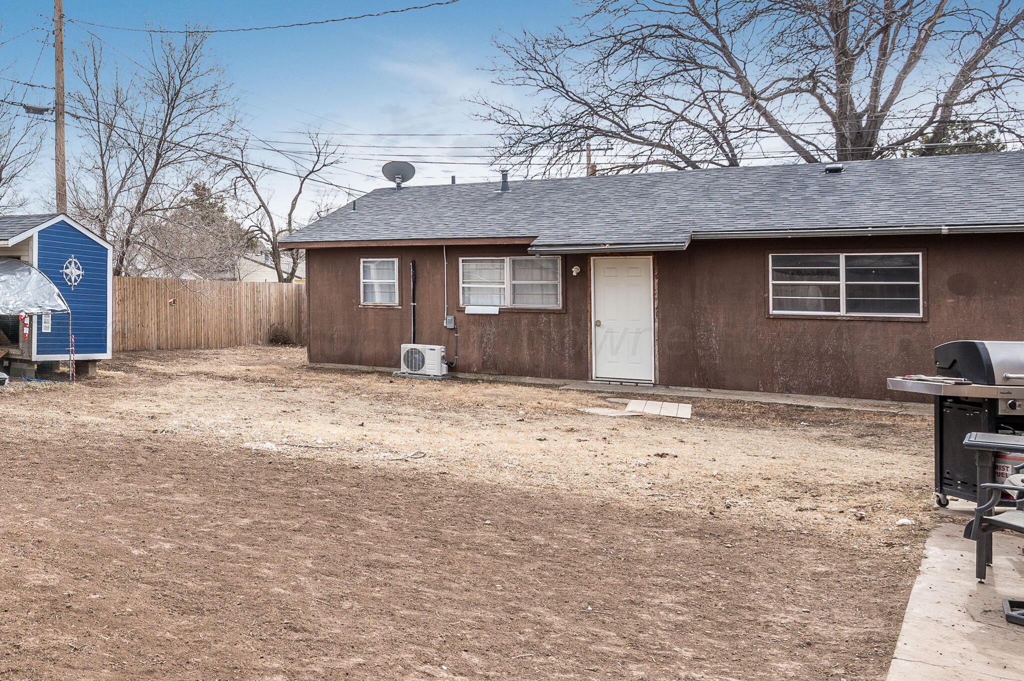 4205 South Bonham Street Amarillo, TX 79110 - Photo 19 of 24 a front view of a house with a yard and garage