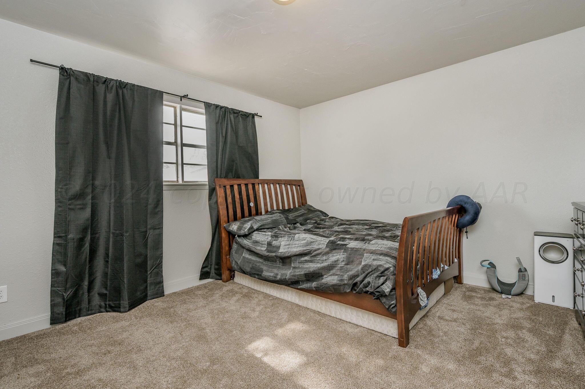 4205 South Bonham Street Amarillo, TX 79110 - Photo 21 of 24 a bedroom with a bed and a window