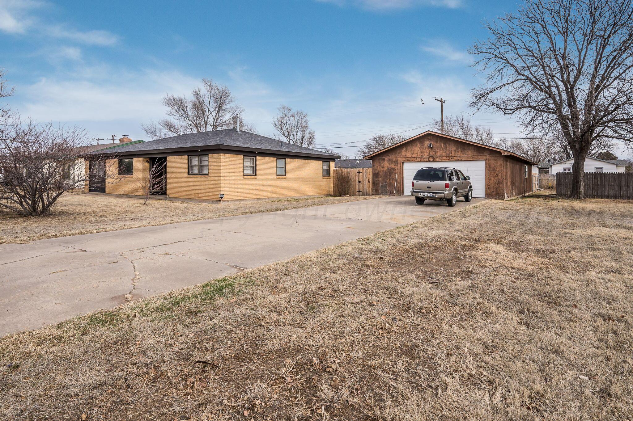 4205 South Bonham Street Amarillo, TX 79110 - Photo 3 of 24 a front view of a house with a yard and garage