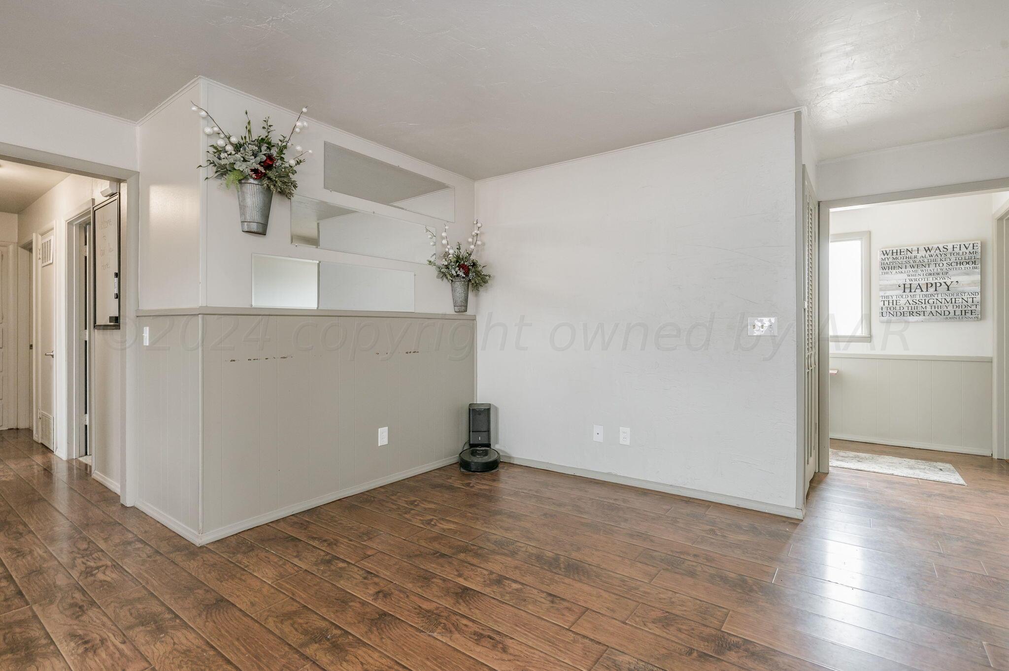 4205 South Bonham Street Amarillo, TX 79110 - Photo 10 of 24 wooden floor in an empty room with a window