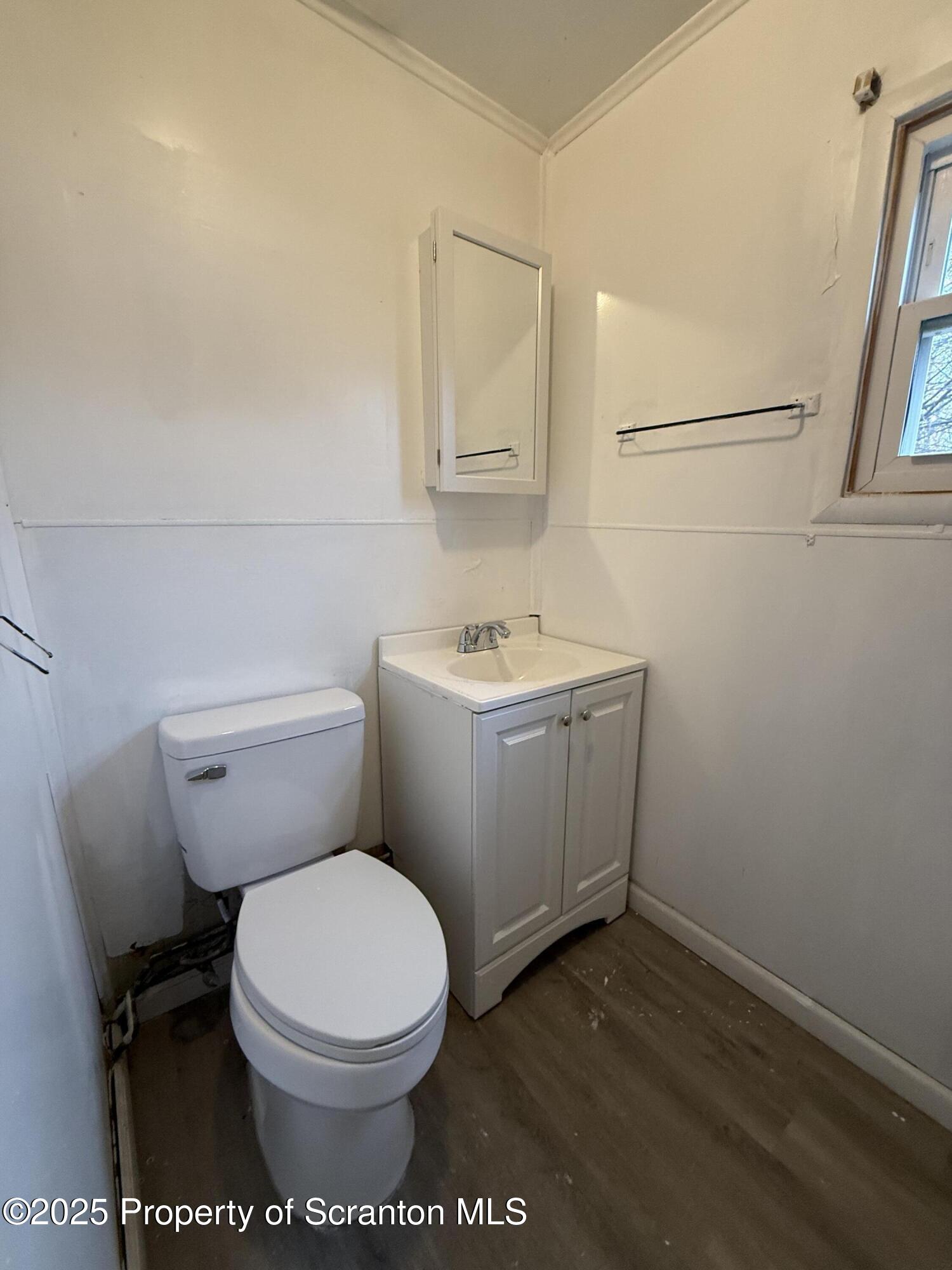 203 Greenbush Street Scranton, PA 18508 - Photo 11 of 20 a white toilet sitting next to a bathroom sink
