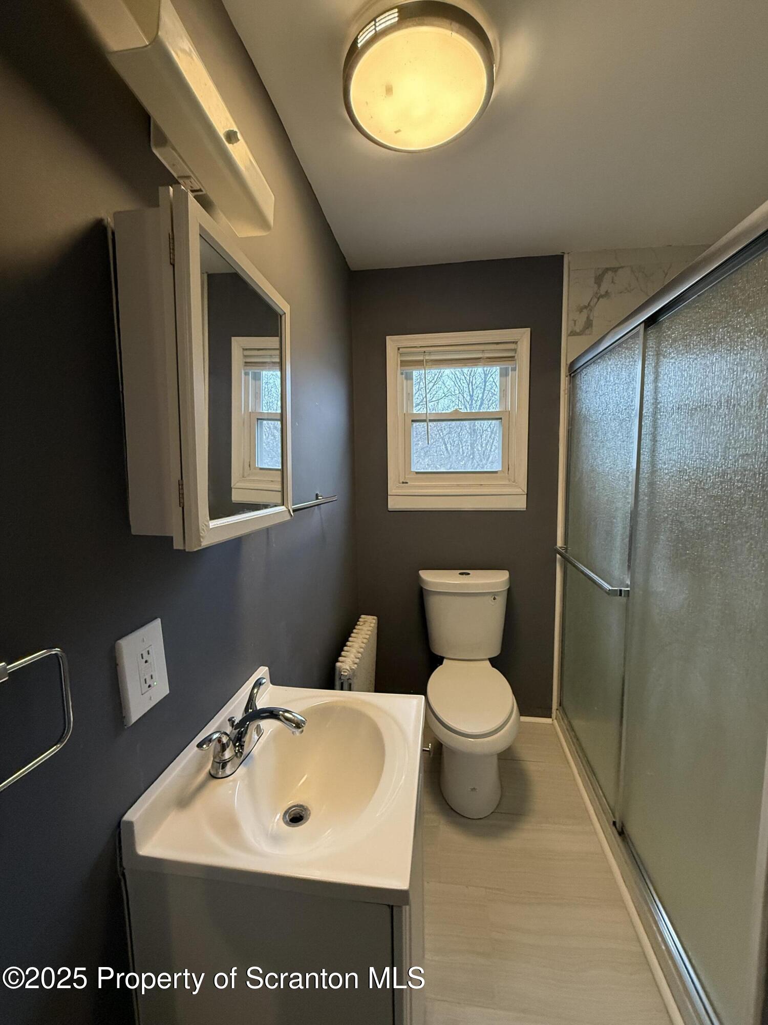 203 Greenbush Street Scranton, PA 18508 - Photo 14 of 20 a bathroom with a toilet sink and a mirror