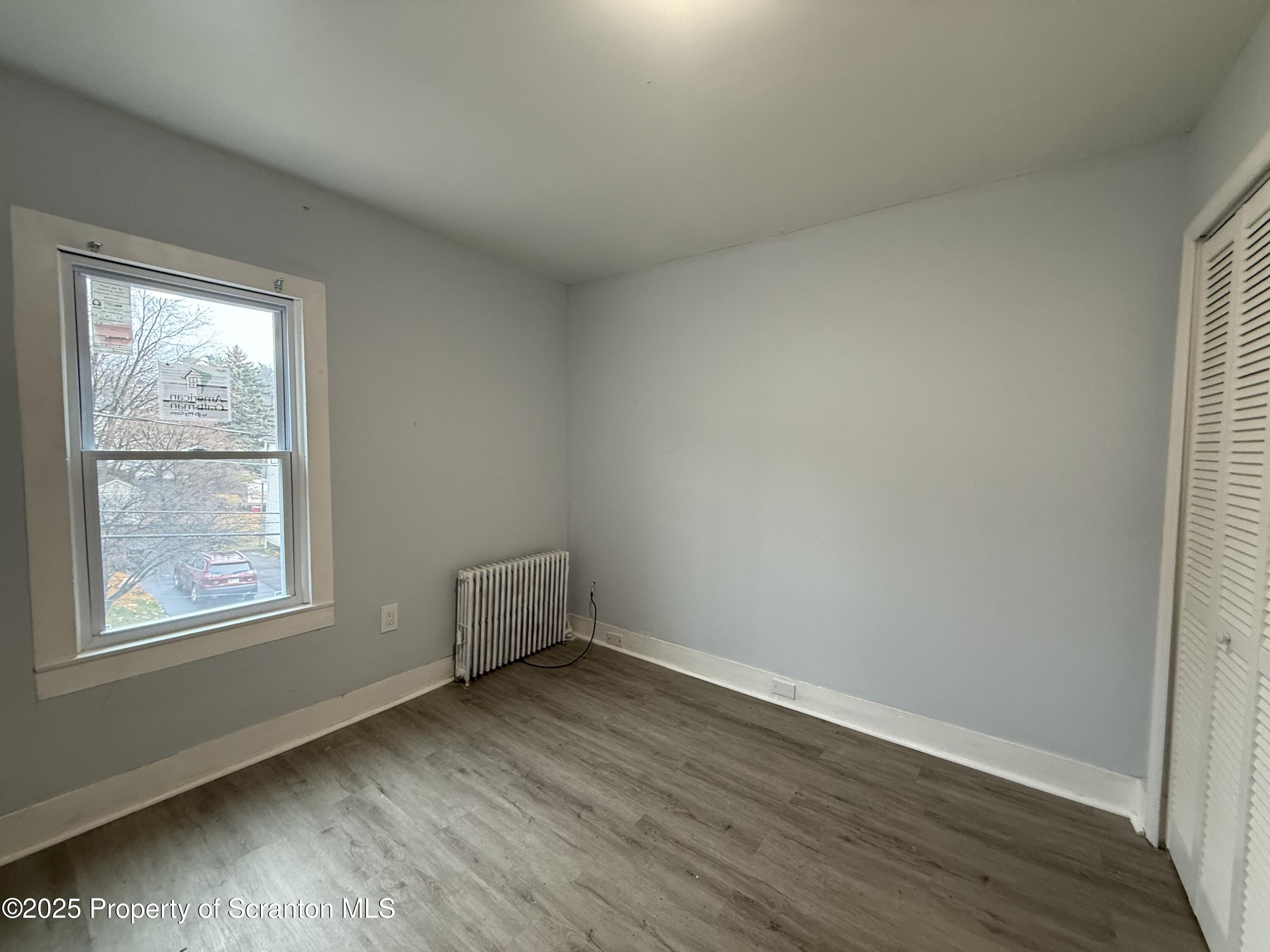 203 Greenbush Street Scranton, PA 18508 - Photo 20 of 20 an empty room with wooden floor and windows