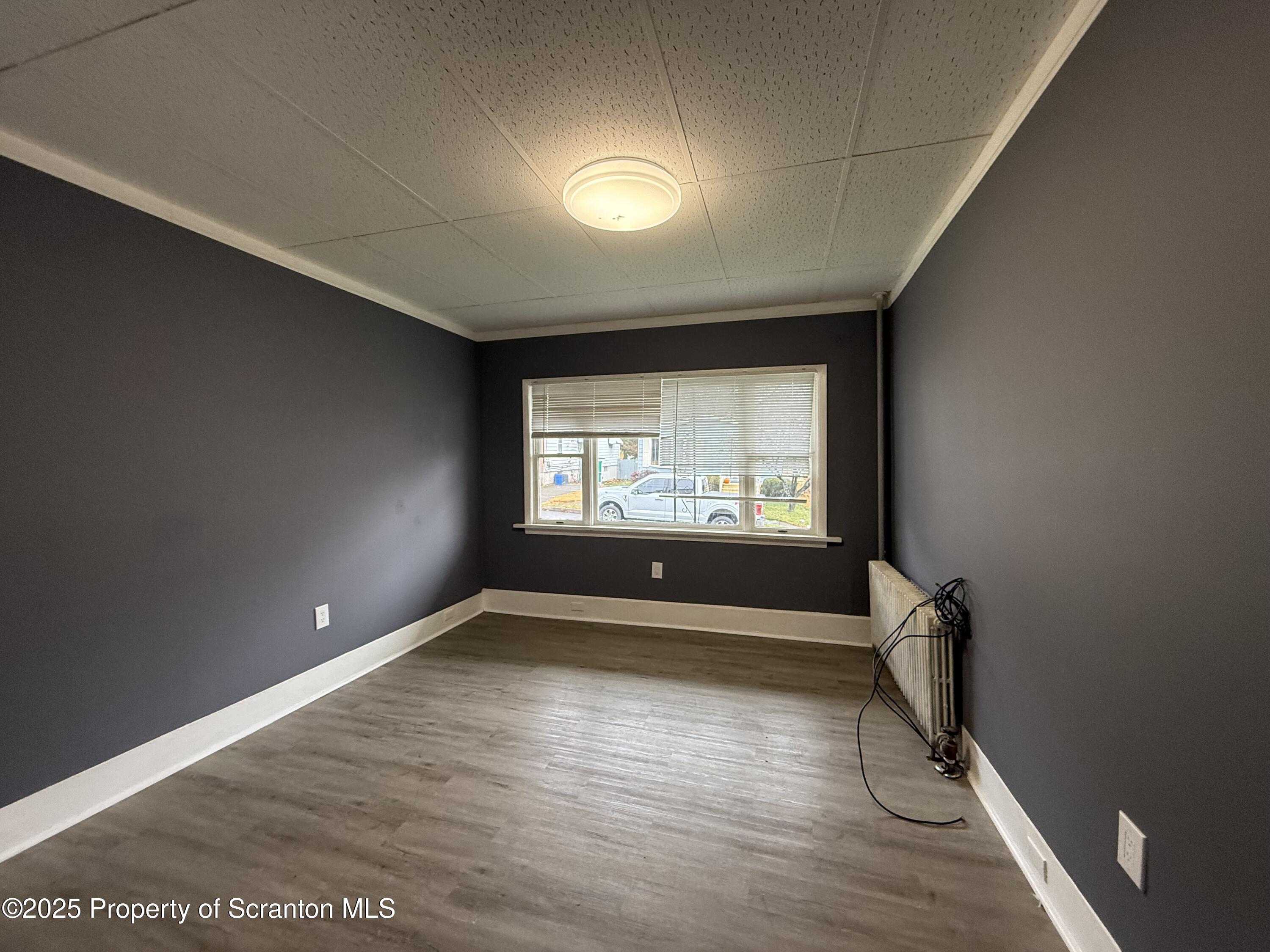 203 Greenbush Street Scranton, PA 18508 - Photo 6 of 20 a view of empty room with wooden floor and fan