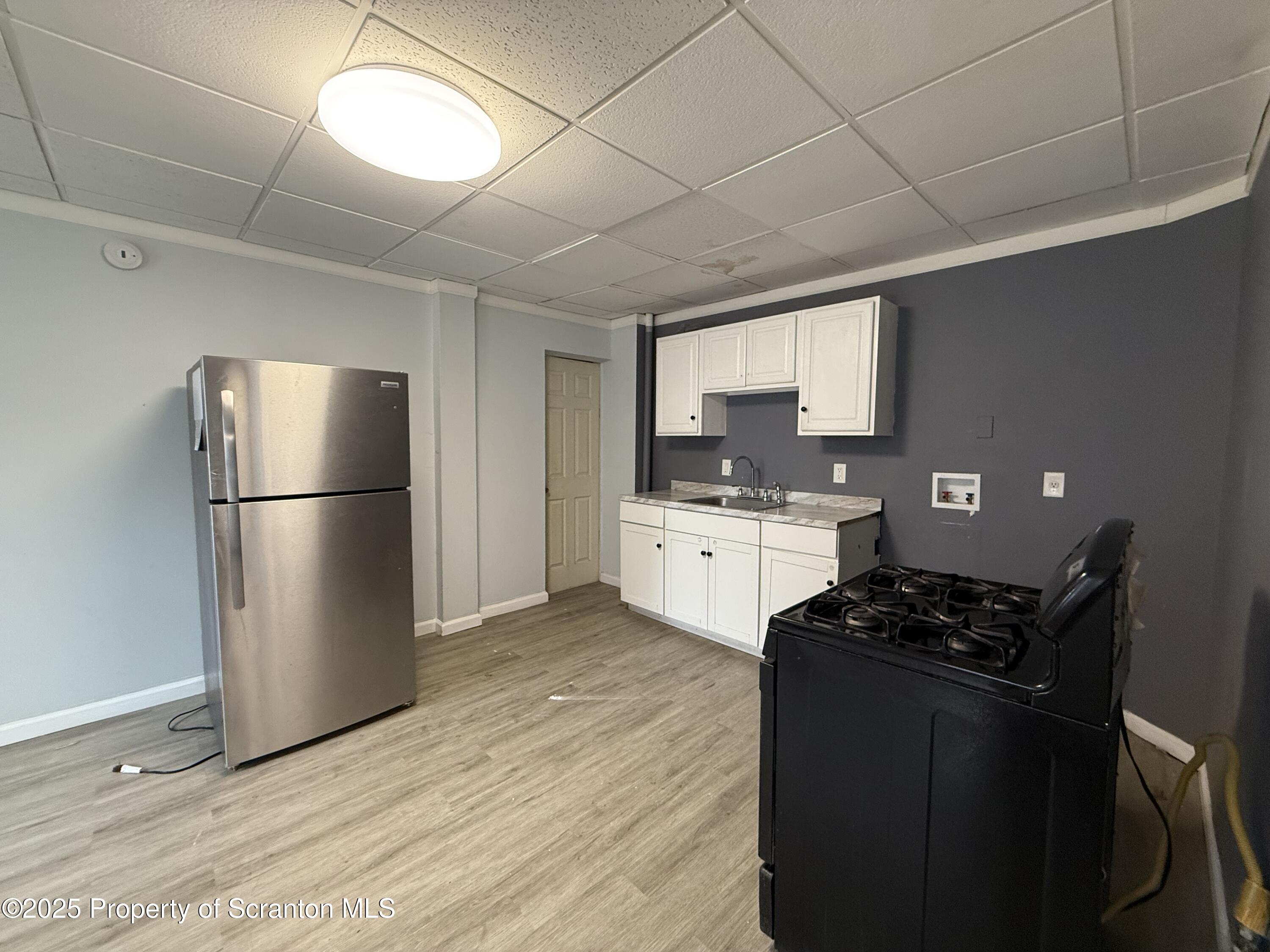 203 Greenbush Street Scranton, PA 18508 - Photo 7 of 20 a kitchen with stainless steel appliances a refrigerator a sink a stove a microwave and cabinets