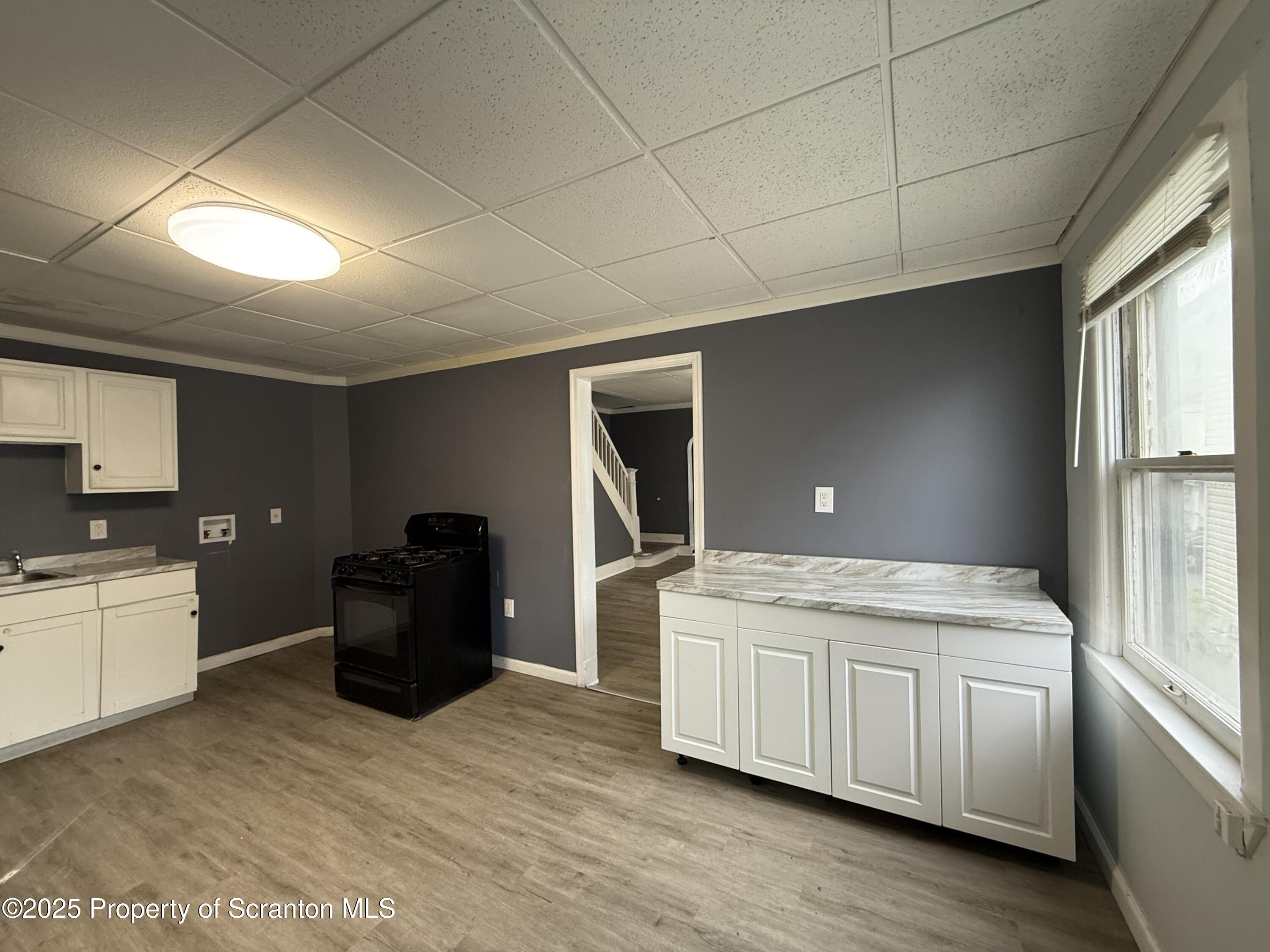 203 Greenbush Street Scranton, PA 18508 - Photo 9 of 20 a kitchen with a stove sink and cabinets