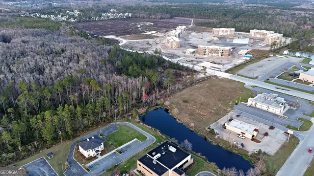 an aerial view of a house garden space and mountain view in back