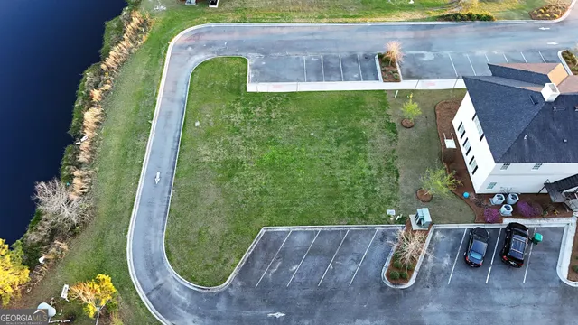 an aerial view of a house with garden space and swimming pool