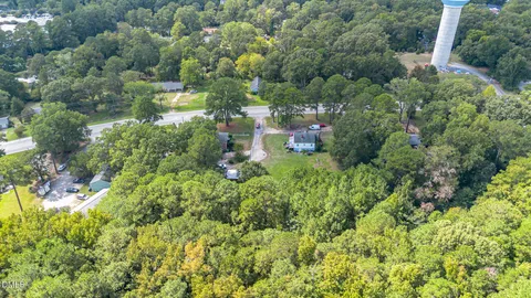 a view of a city with lush green forest