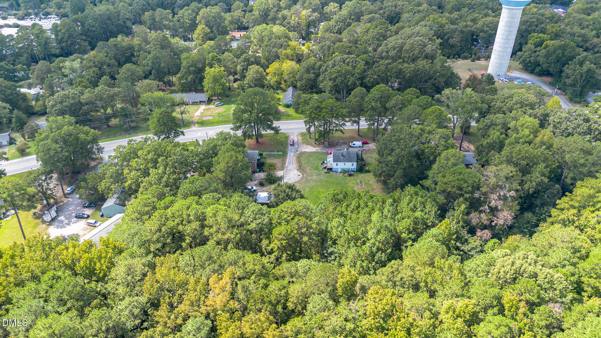 655-659 Sunnybrook Road Raleigh, NC 27610 - Photo 13 of 14 a view of a house with a lush green forest