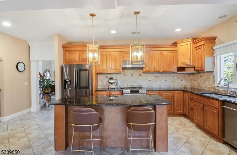 68 Horseneck Road Montville, NJ 07045 - Photo 11 of 34 a kitchen with kitchen island granite countertop a sink counter top space appliances and cabinets