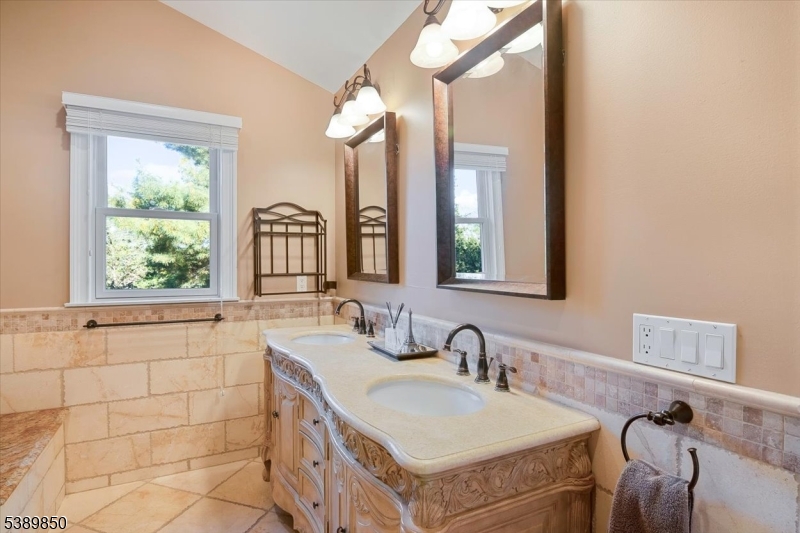 68 Horseneck Road Montville, NJ 07045 - Photo 17 of 34 a bathroom with a double vanity sink and a mirror