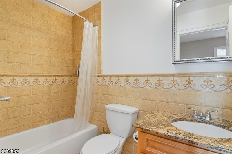 68 Horseneck Road Montville, NJ 07045 - Photo 21 of 34 a bathroom with a granite countertop toilet sink and mirror