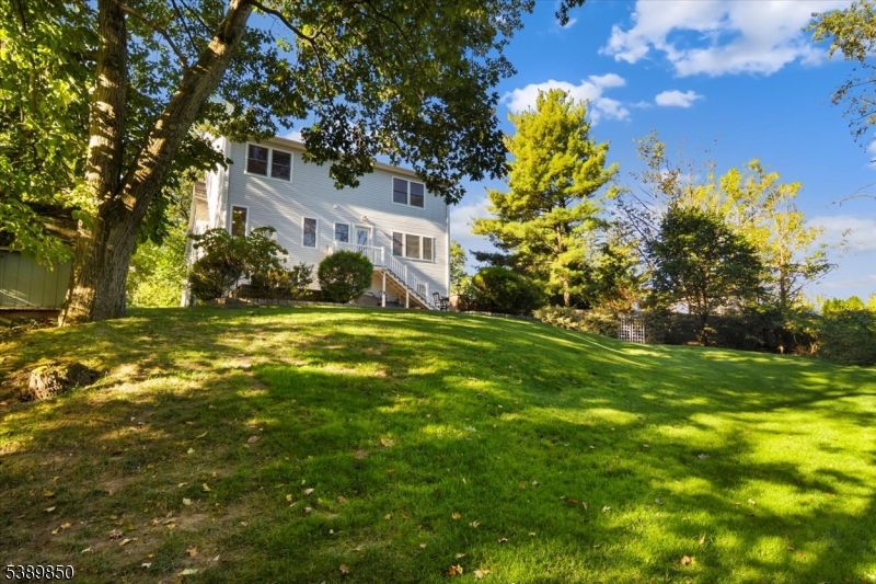 68 Horseneck Road Montville, NJ 07045 - Photo 27 of 34 a yellow house with garden in front of it