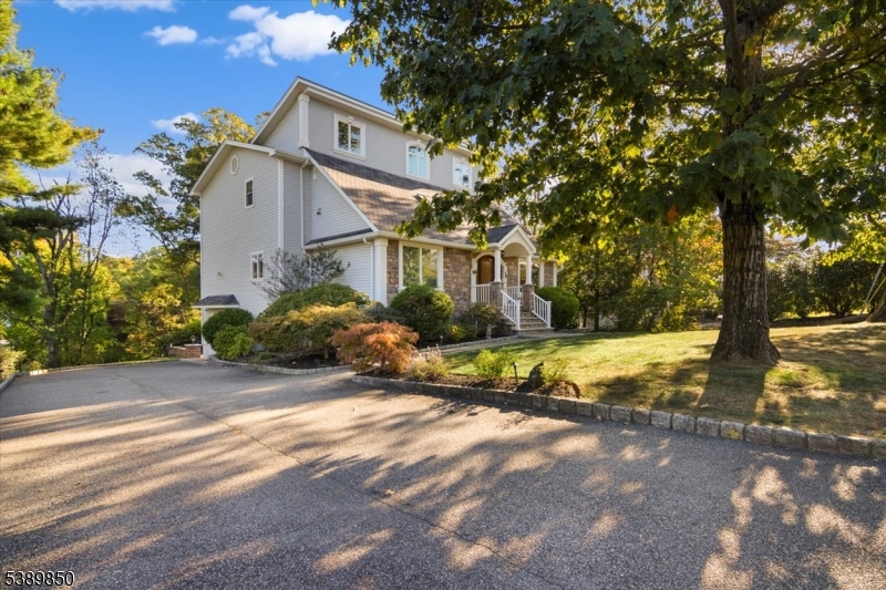 68 Horseneck Road Montville, NJ 07045 - Photo 33 of 34 a view of a white house next to a road with big trees