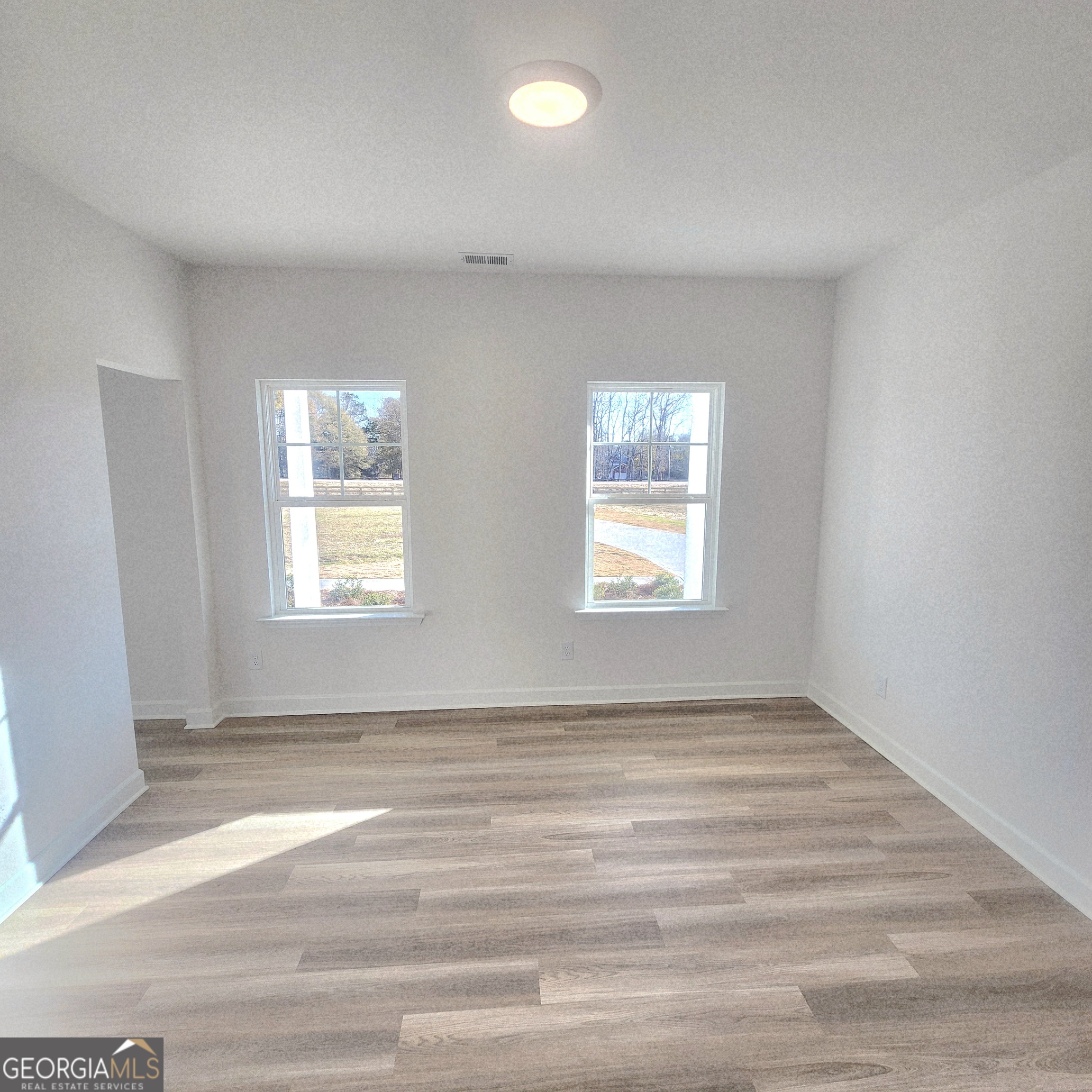 431 North Unity Grove Road Locust Grove, GA 30248 - Photo 13 of 18 an empty room with windows