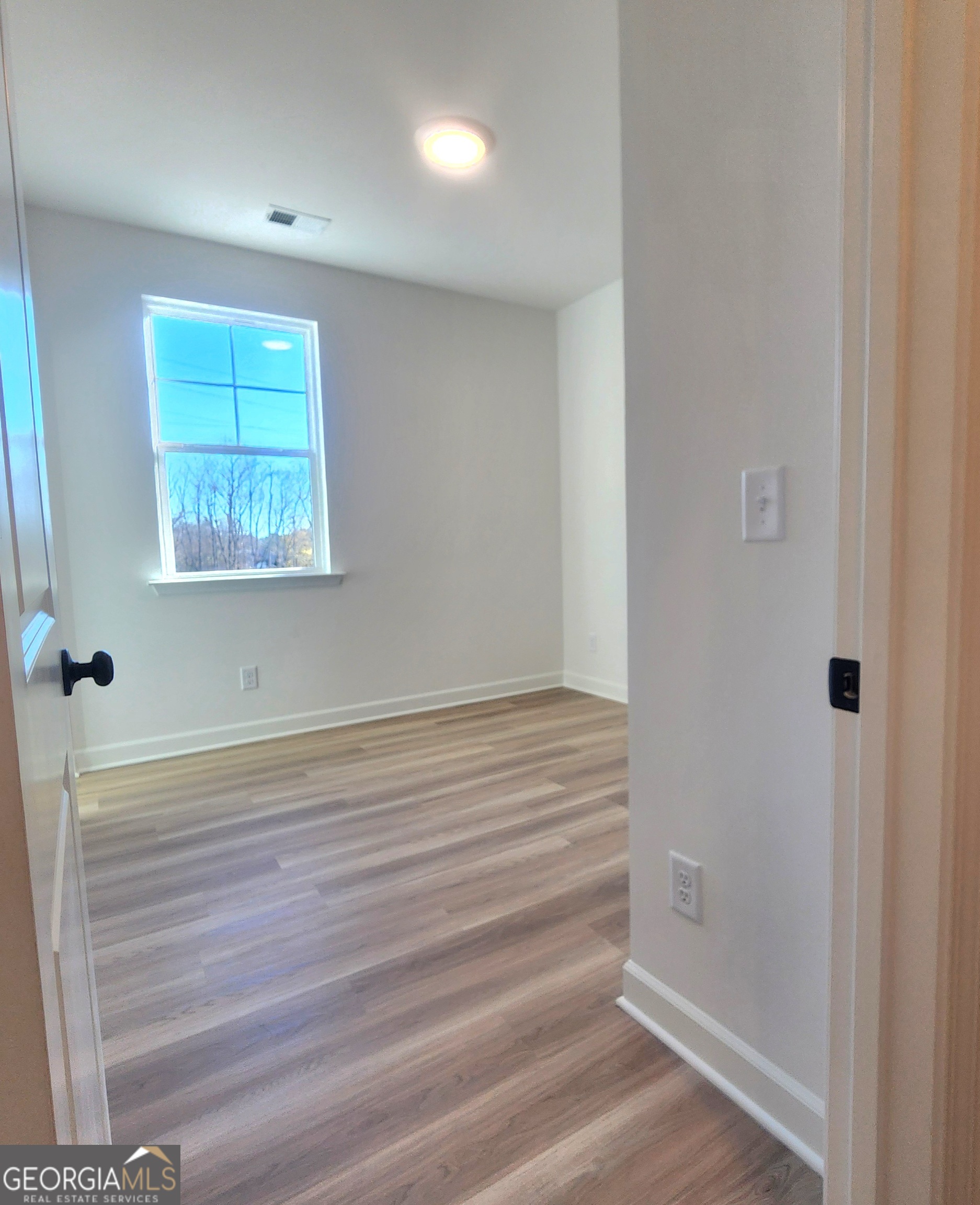 431 North Unity Grove Road Locust Grove, GA 30248 - Photo 16 of 18 a view of empty room with wooden floor and fan