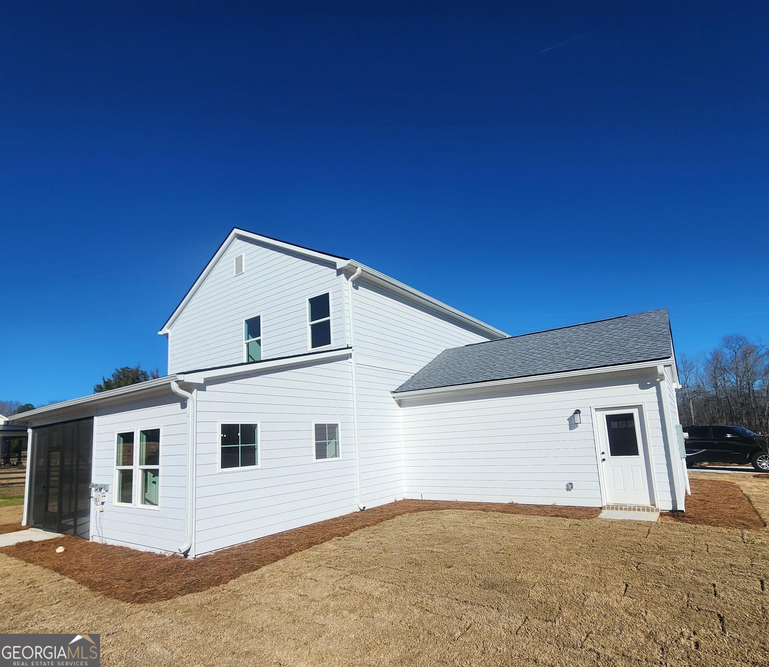 431 North Unity Grove Road Locust Grove, GA 30248 - Photo 4 of 18 a view of a white house with a yard