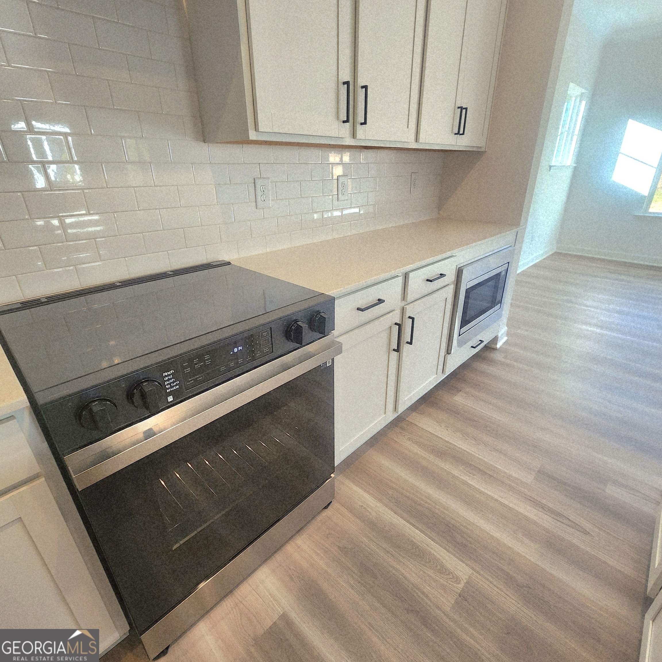 431 North Unity Grove Road Locust Grove, GA 30248 - Photo 7 of 18 a kitchen with granite countertop white cabinets and white appliances