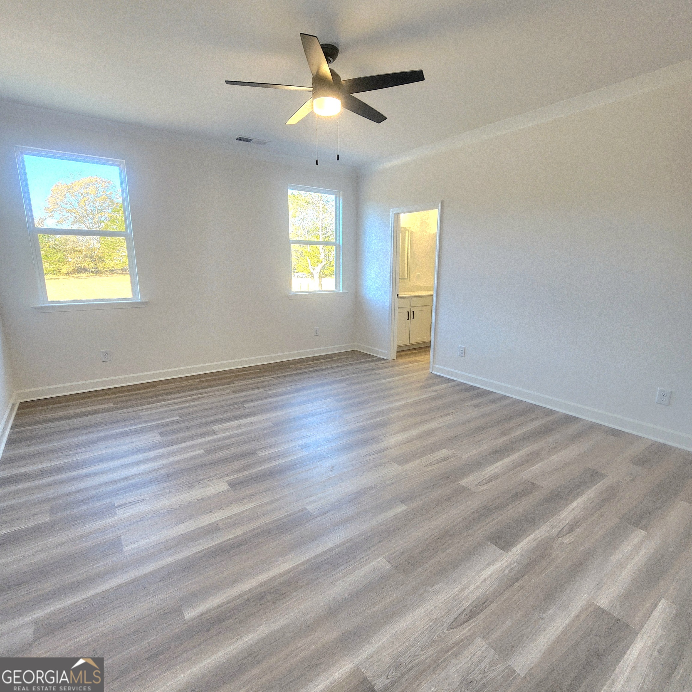 431 North Unity Grove Road Locust Grove, GA 30248 - Photo 10 of 18 wooden floor in an empty room with a window