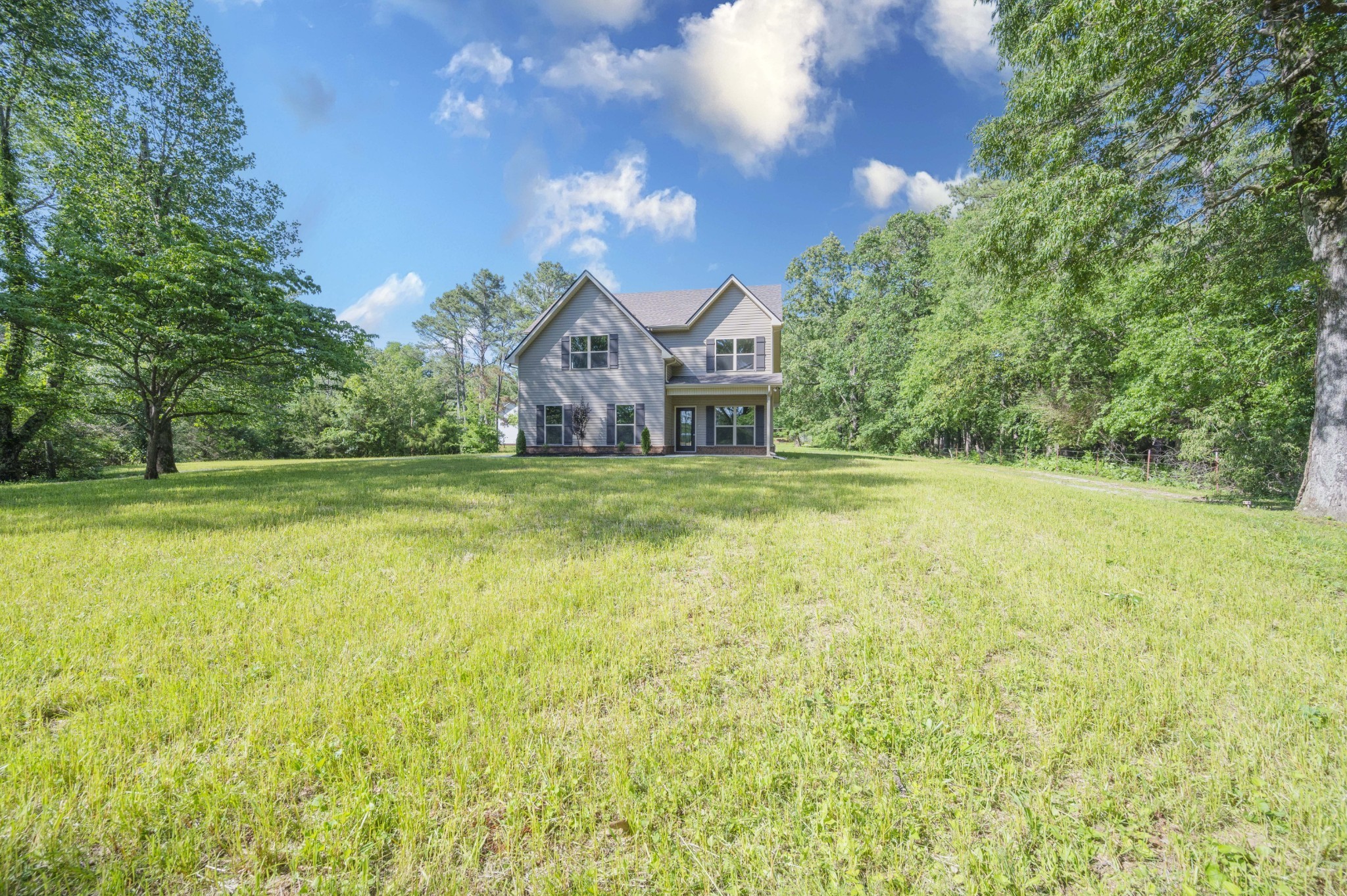 283 Providence Road Pelham, TN 37366 - Photo 2 of 24 a view of a big house with a big yard and large trees