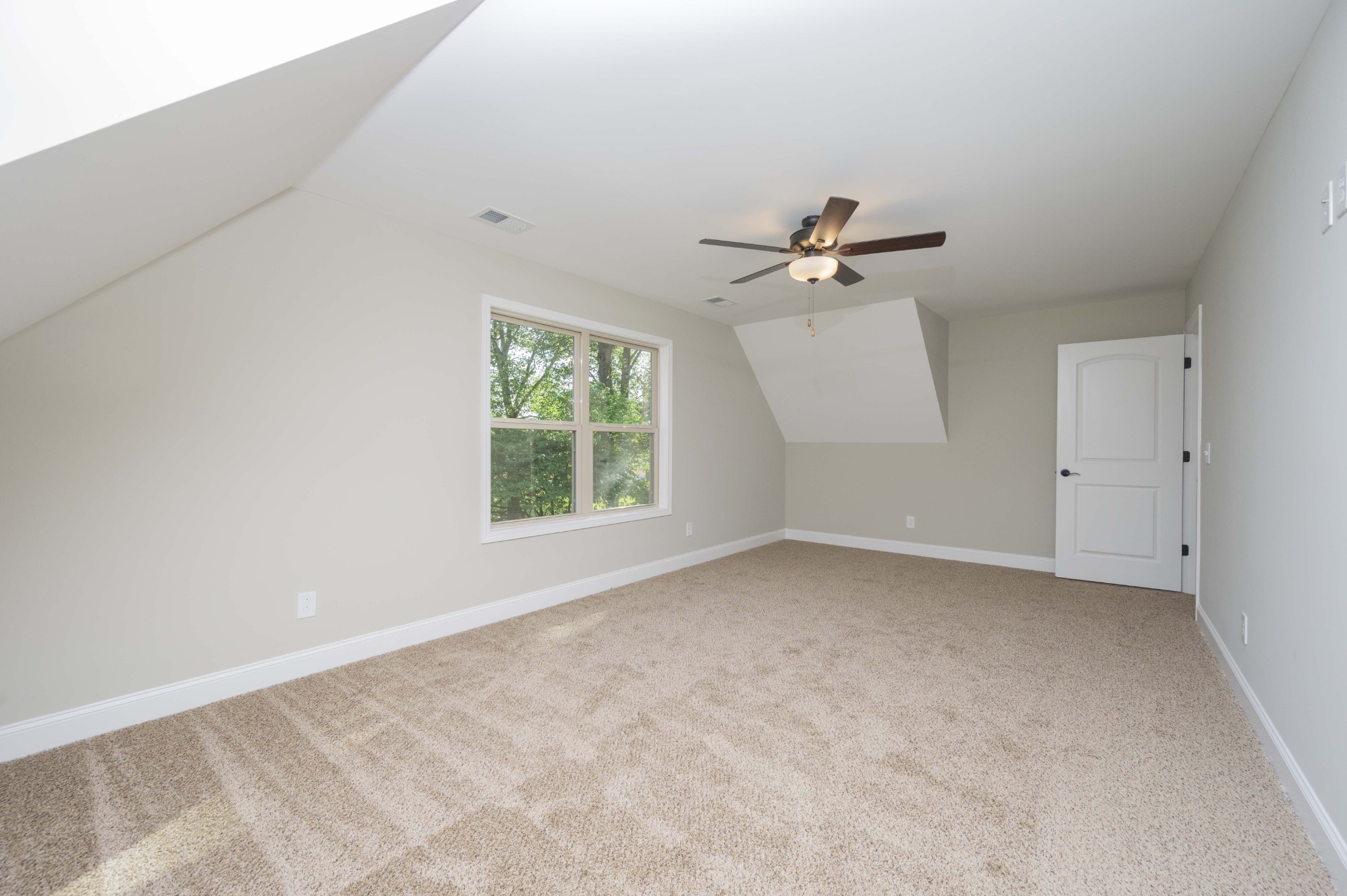 283 Providence Road Pelham, TN 37366 - Photo 21 of 24 an empty room with a ceiling fan and a window