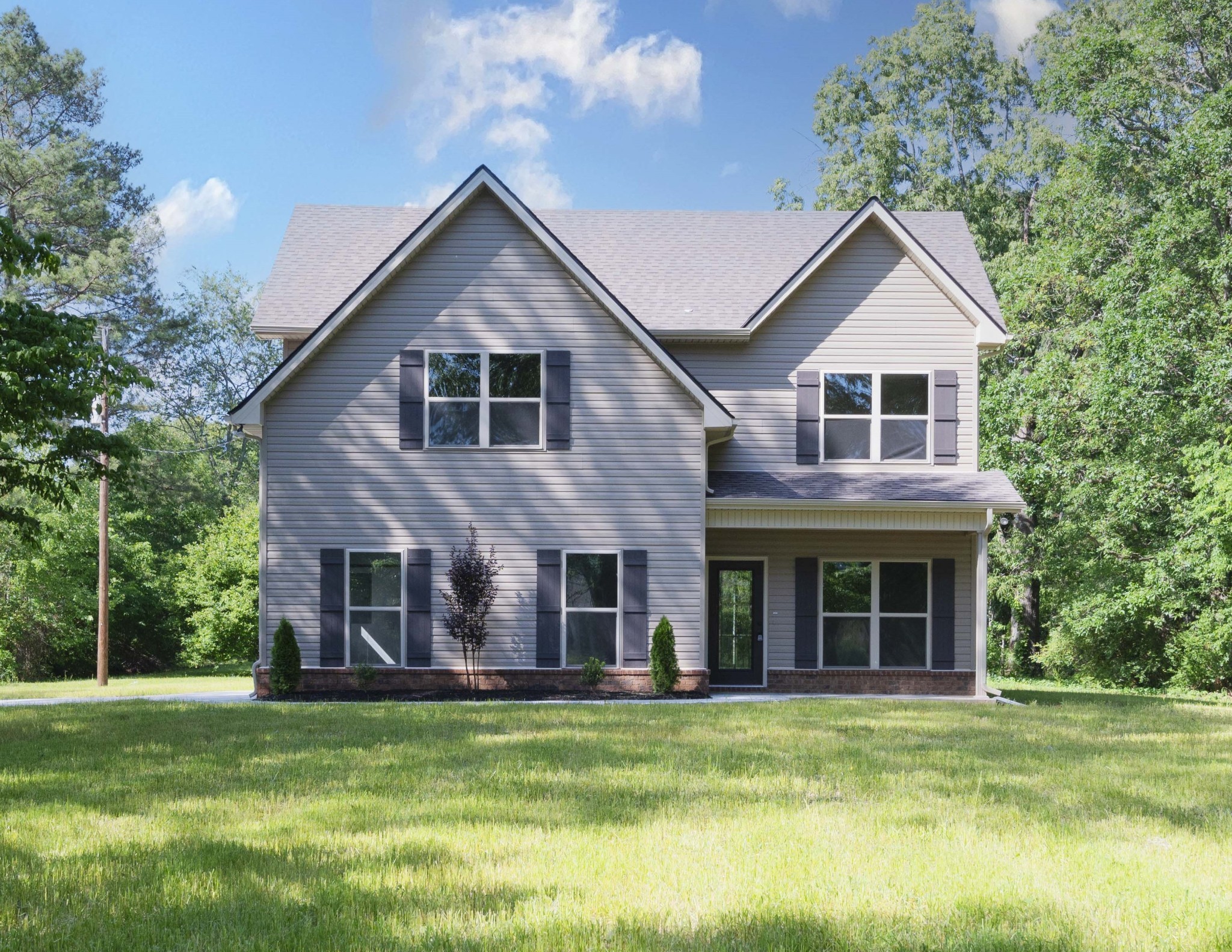 283 Providence Road Pelham, TN 37366 - Photo 3 of 24 a front view of a house with a garden and porch