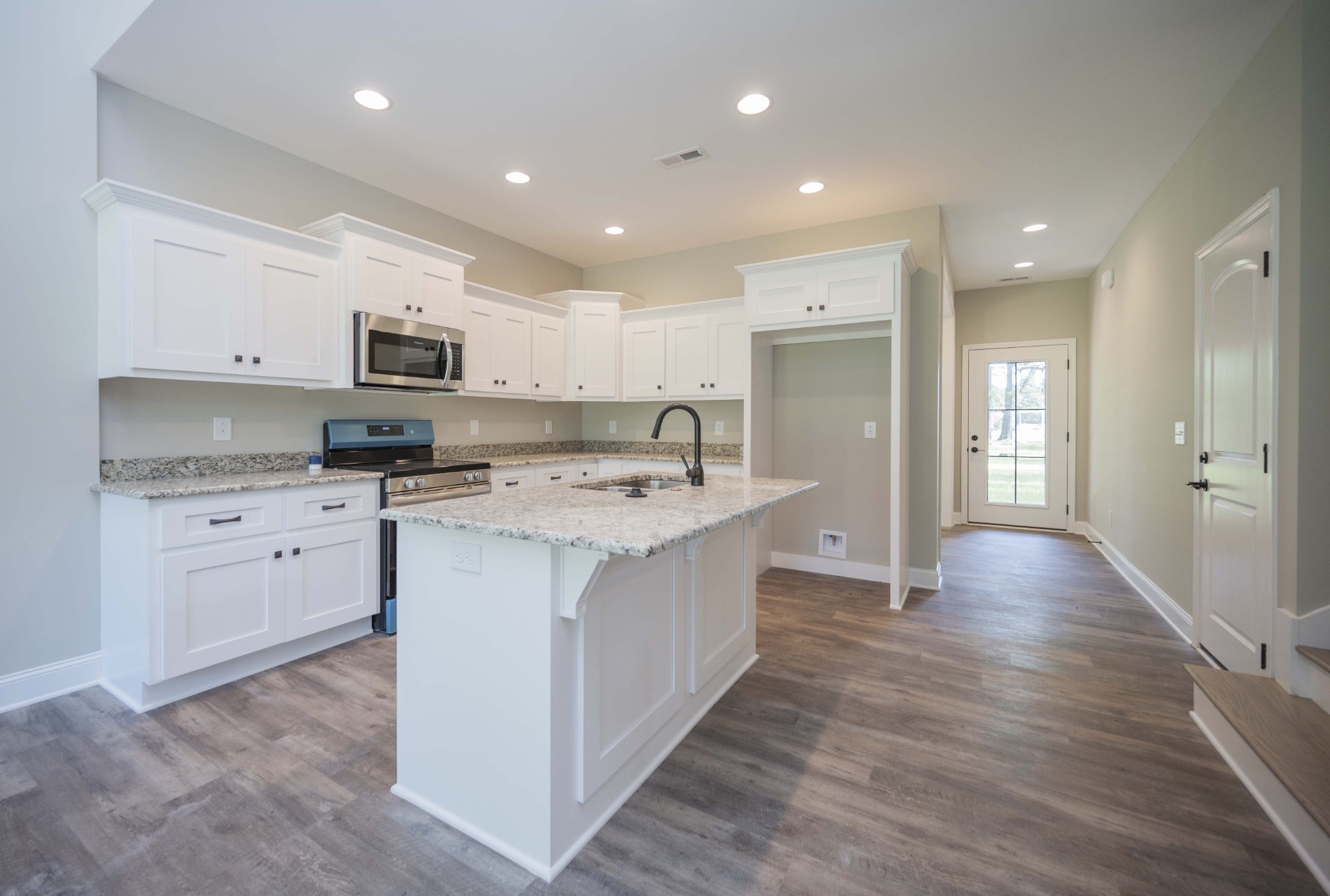 283 Providence Road Pelham, TN 37366 - Photo 5 of 24 a kitchen with kitchen island granite countertop a sink and refrigerator
