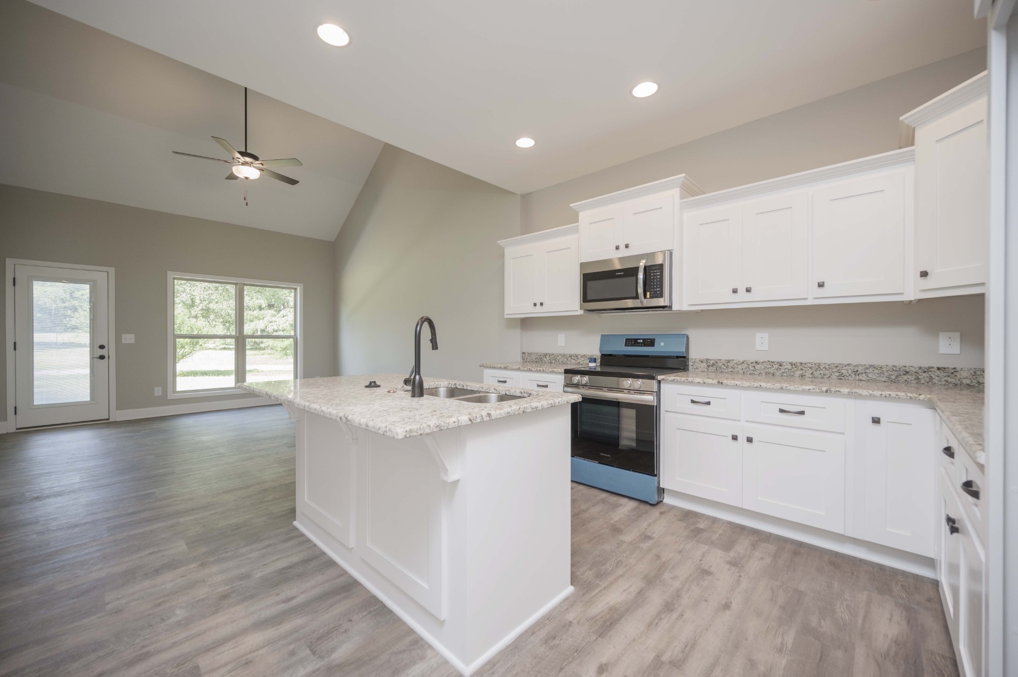 283 Providence Road Pelham, TN 37366 - Photo 7 of 24 a kitchen with granite countertop white cabinets and stainless steel appliances