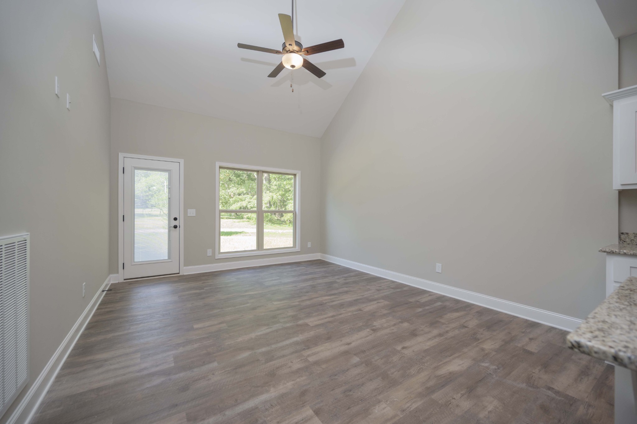 283 Providence Road Pelham, TN 37366 - Photo 9 of 24 wooden floor in an empty room with a window
