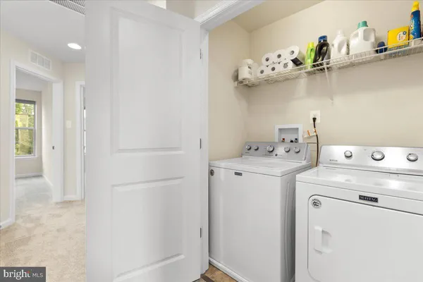 a view of washer and dryer with kitchen countertops