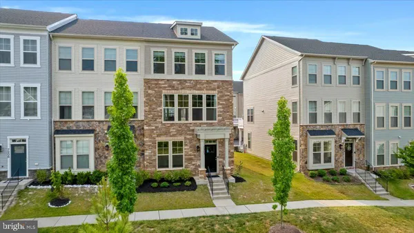 a front view of a residential apartment building with a yard