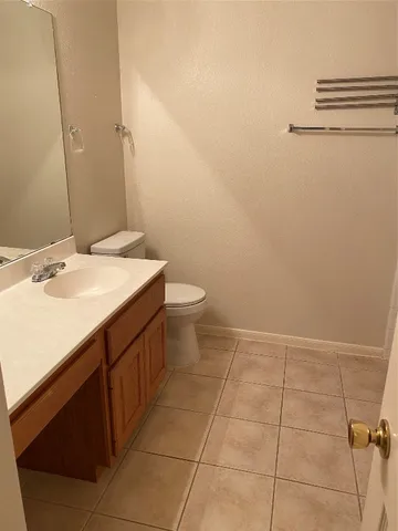 a bathroom with a sink a toilet and a mirror