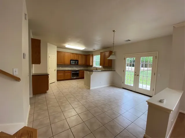 a open kitchen with cabinets and stainless steel appliances