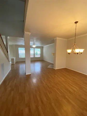 a view of a room with wooden floor and window