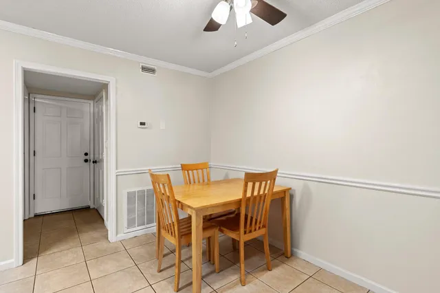 a view of a livingroom with furniture and chandelier fan