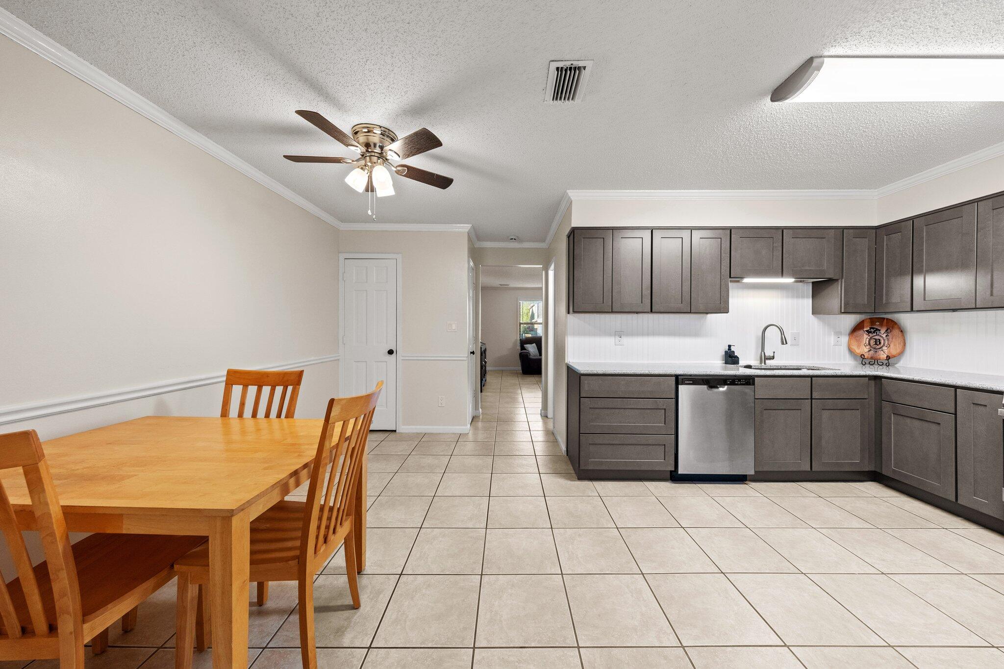 114 4th Avenue Shalimar, FL 32579 - Photo 15 of 59 a kitchen with stainless steel appliances a stove a sink cabinets and a dining table