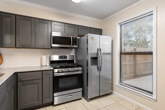 a kitchen with a refrigerator stove and cabinets