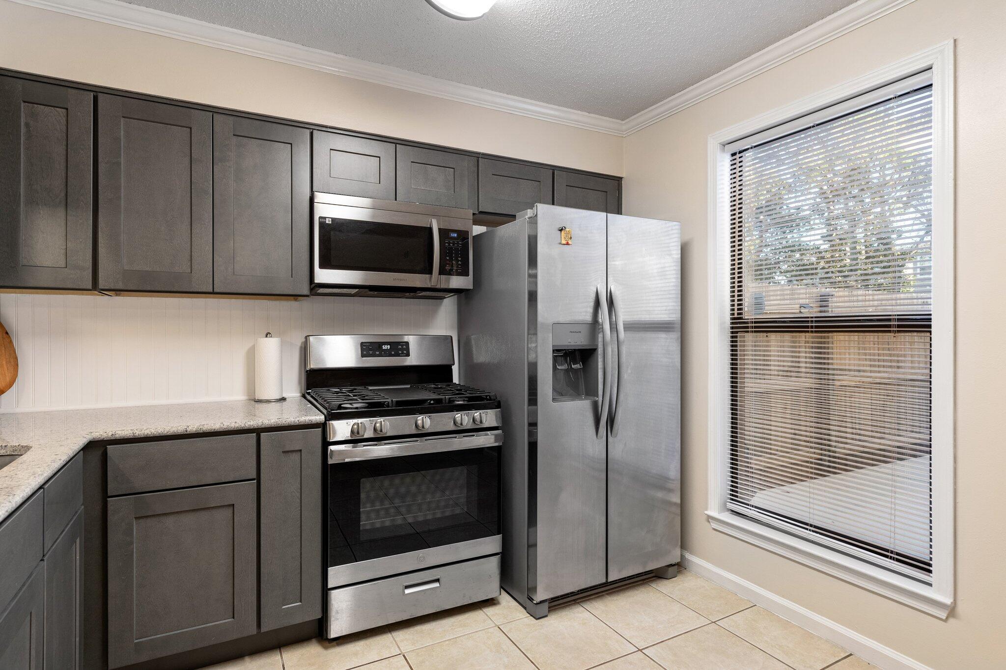 114 4th Avenue Shalimar, FL 32579 - Photo 19 of 59 a kitchen with a refrigerator stove and cabinets
