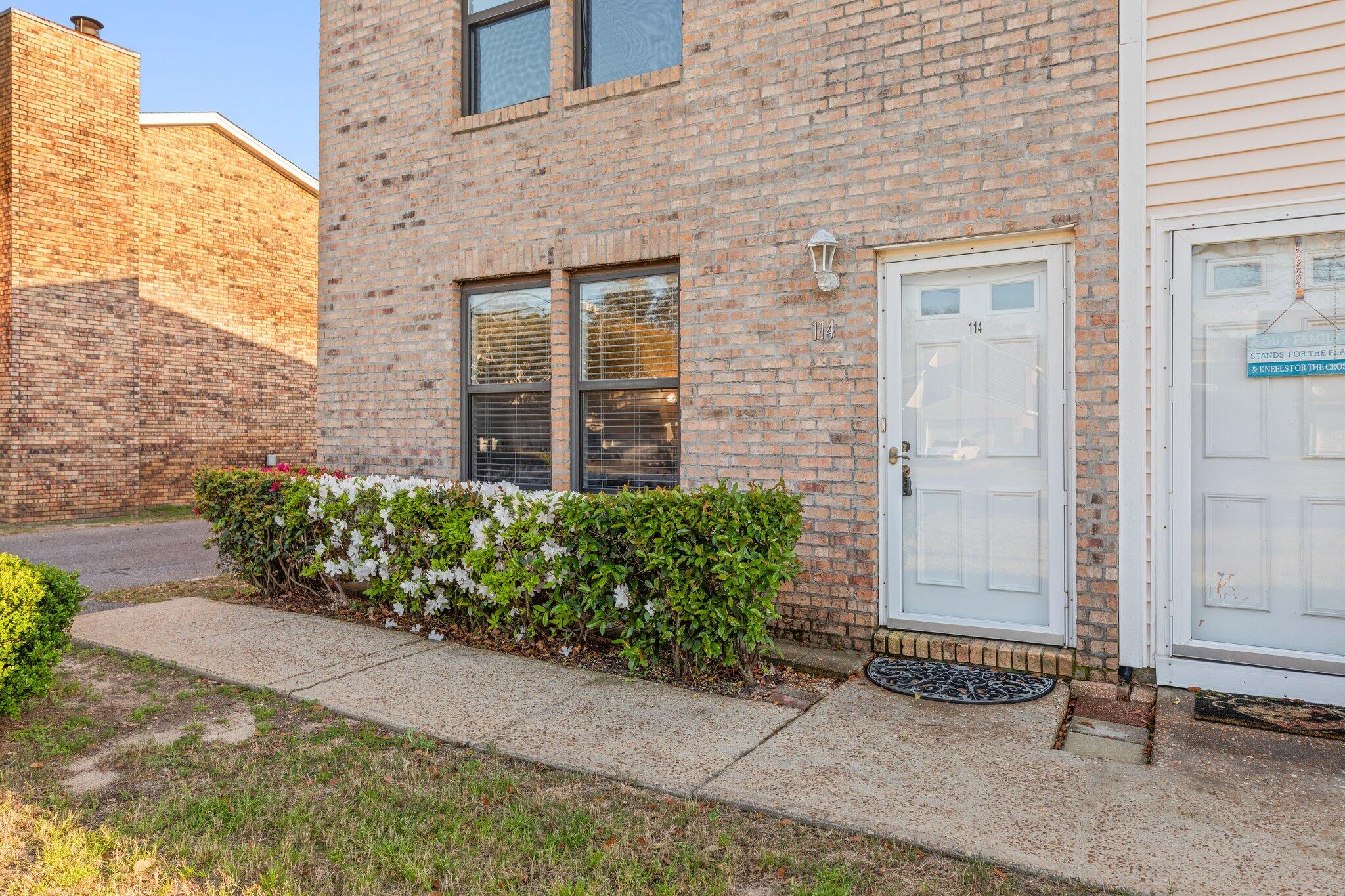 114 4th Avenue Shalimar, FL 32579 - Photo 2 of 59 a front view of a house with a garden