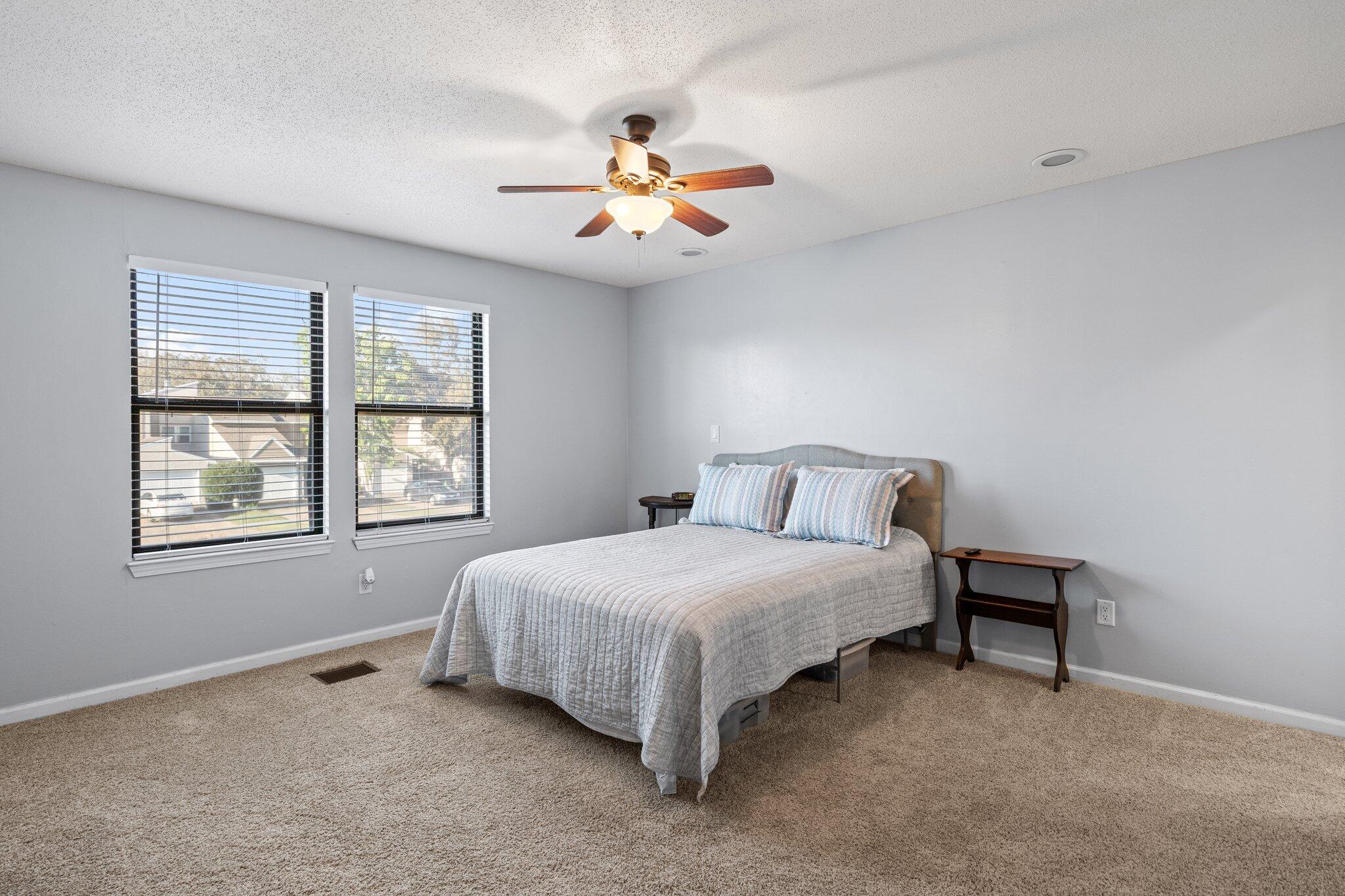 114 4th Avenue Shalimar, FL 32579 - Photo 27 of 59 a bedroom with a bed and a chandelier