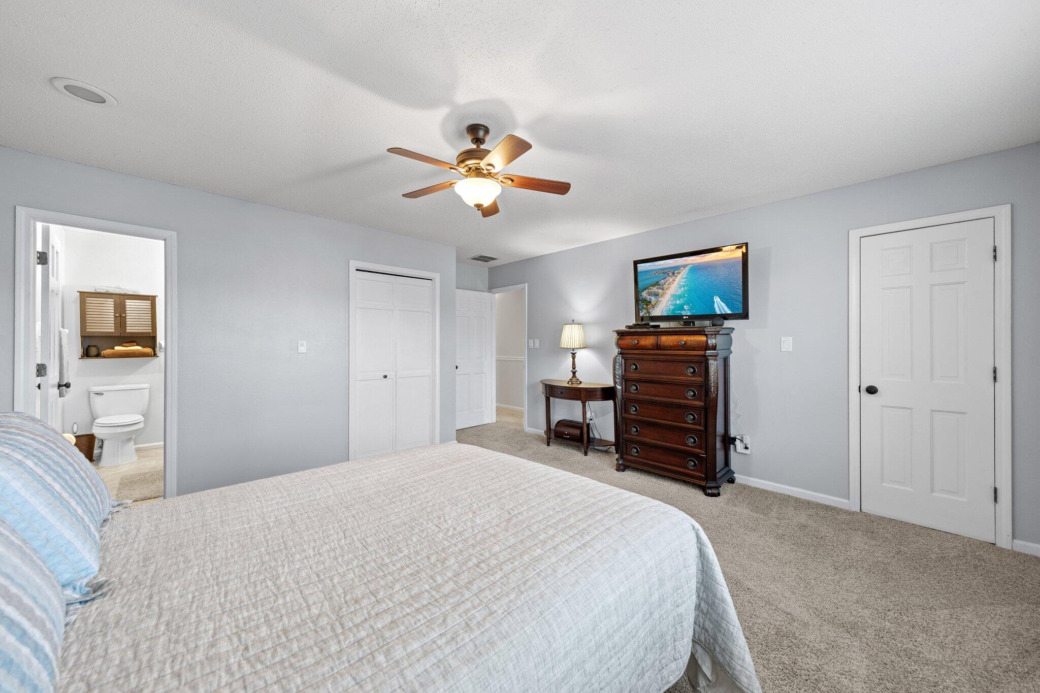114 4th Avenue Shalimar, FL 32579 - Photo 29 of 59 a bedroom with a bed and a chandelier