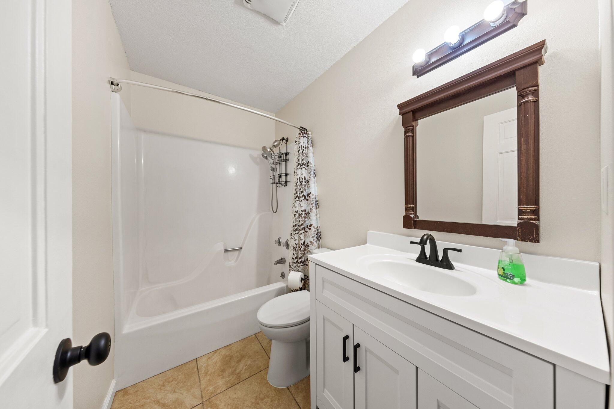 114 4th Avenue Shalimar, FL 32579 - Photo 34 of 59 a bathroom with a sink a toilet and shower