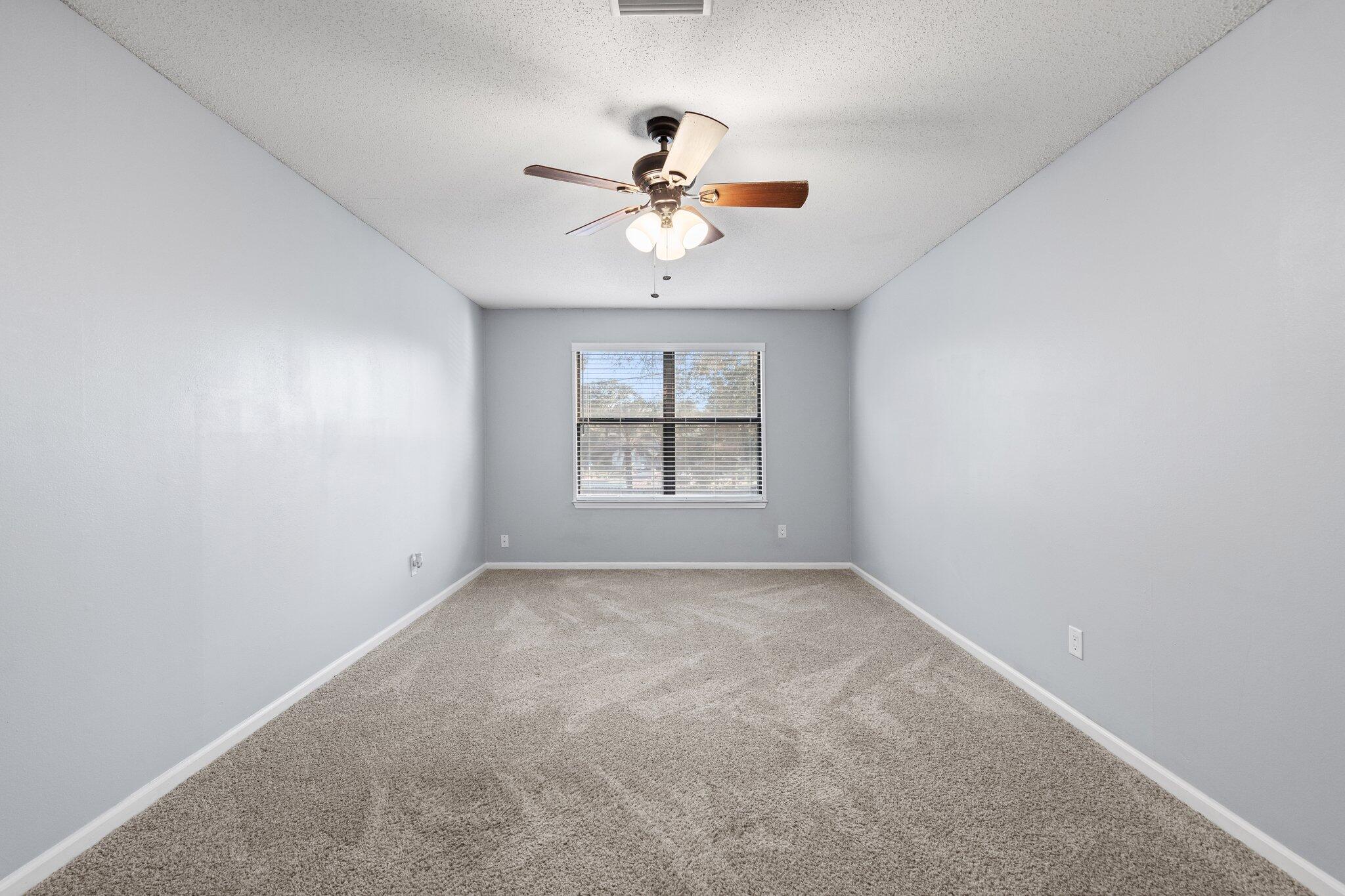 114 4th Avenue Shalimar, FL 32579 - Photo 40 of 59 an empty room with windows and ceiling fan