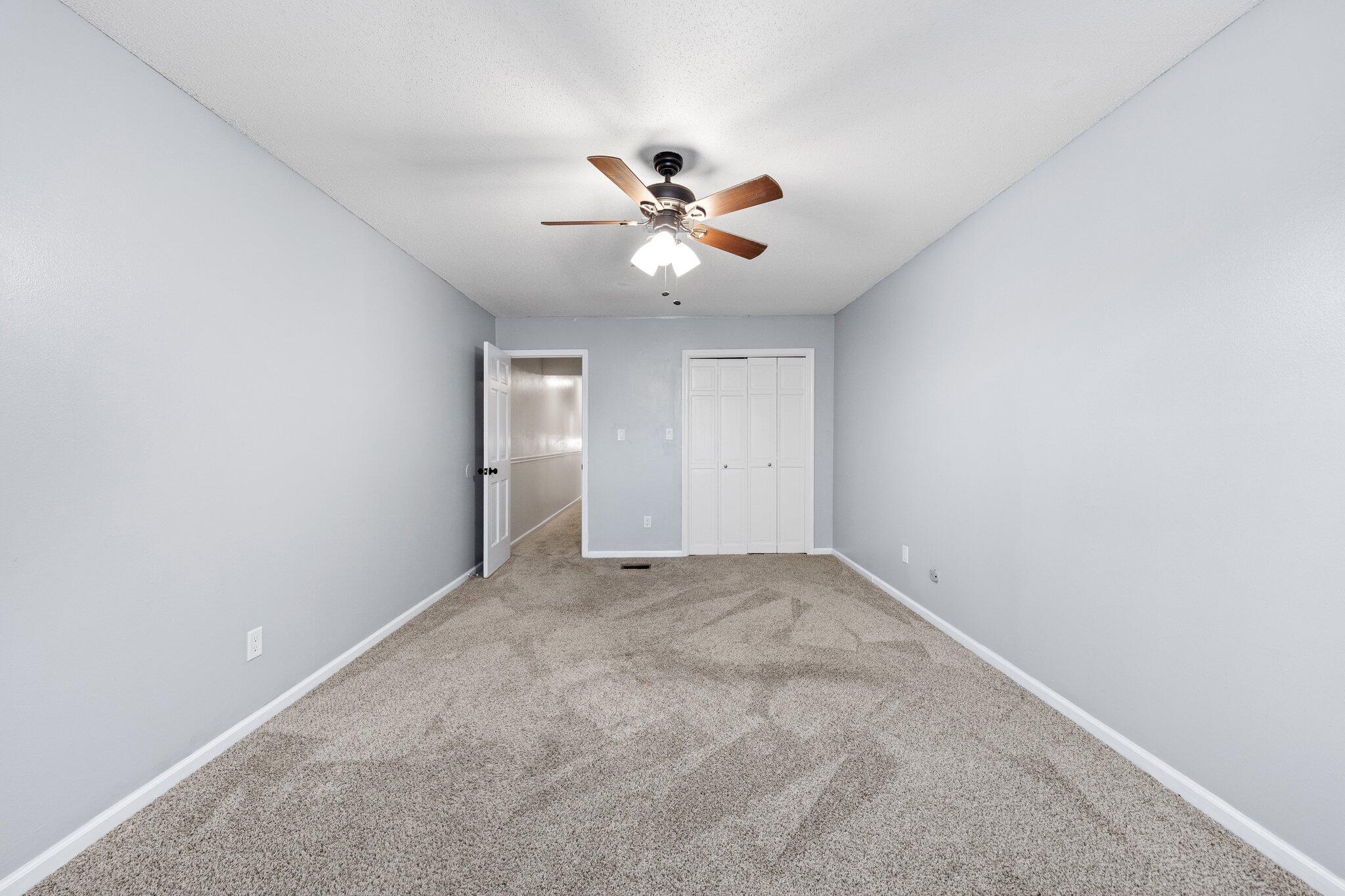 114 4th Avenue Shalimar, FL 32579 - Photo 41 of 59 an empty room with closet and a ceiling fan